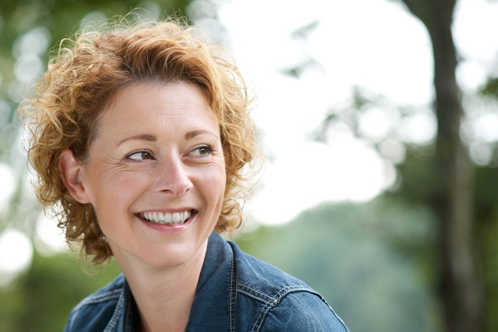 happy woman outside smiling