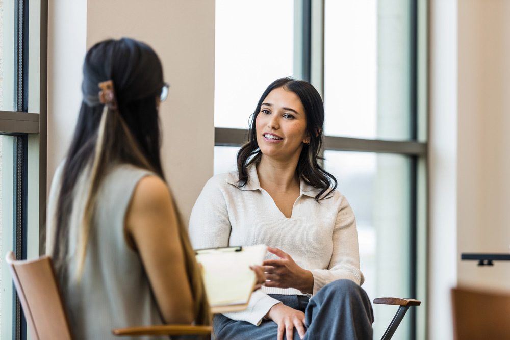 Woman talking with her therapist in addiction treatment