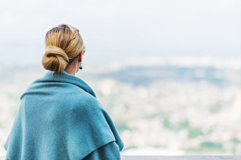woman looking out over a city