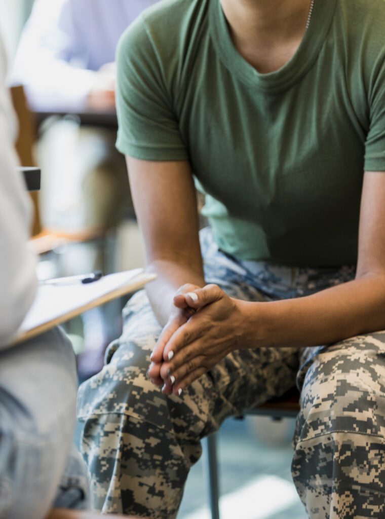 Close up photo female soldier leaning forward in seat