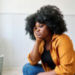 sad woman sitting with her head in her hands