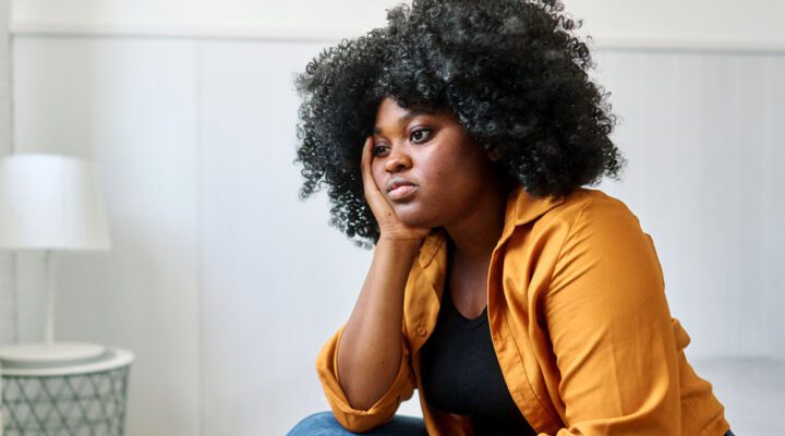 sad woman sitting with her head in her hands